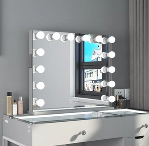 Makeup vanity with mirror and lights against a gray wall