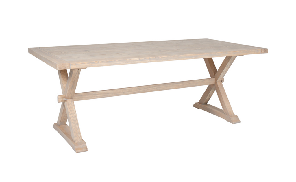 Wooden dining table with X-shaped legs on a white background