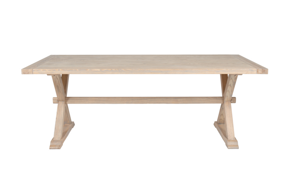 Light wooden dining table on a white background