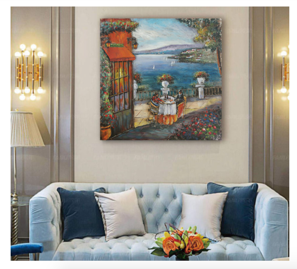 Painting of a scenic outdoor setting above a light blue sofa with decorative pillows.