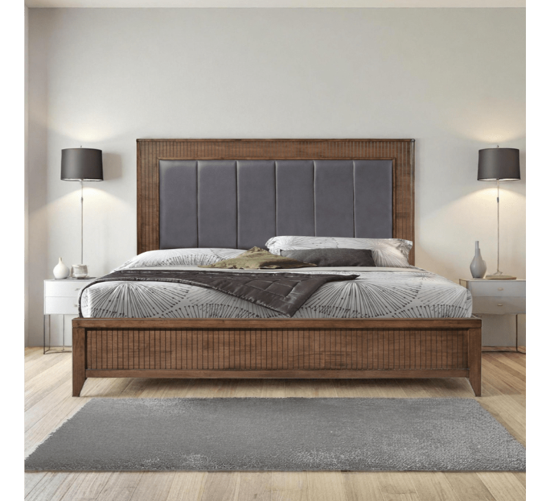 Bedroom with a wooden bed frame, gray upholstered headboard, and nightstands with lamps.