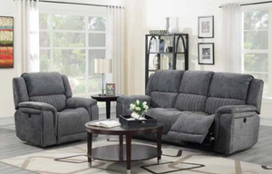 Gray reclining sofa set in a living room with a coffee table and decor items.