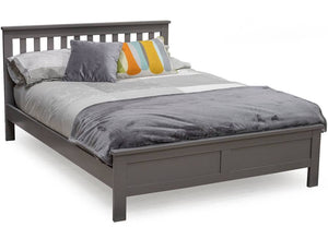 A 4'6ft double bed with gray wooden frame and brown upholstered headboard, adorned with multicolored cushions.