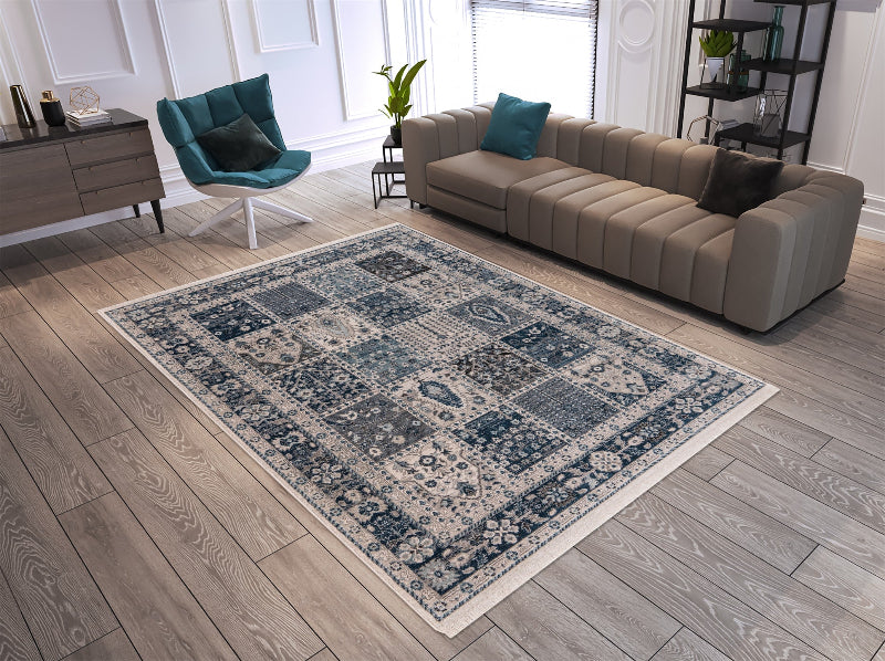 Patterned area rug on a wooden floor with a sofa and chair in a living room setting.