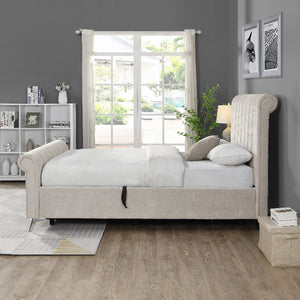 Beige upholstered bed in a room with a large window and decorative elements.