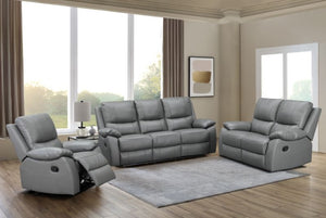 Gray reclining sofa set in a living room with large windows and a rug.