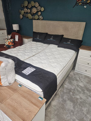 Mattress on display with pillows in a room setting
