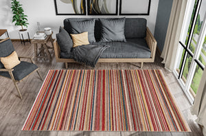 Living room with a striped rug, gray sofa, and chairs.