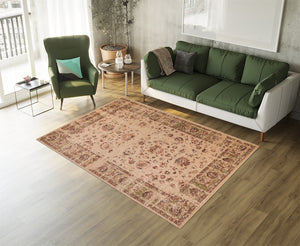 Living room with a green sofa, armchair, and patterned beige rug.