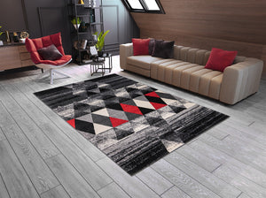 Living room with a geometric patterned rug, beige sofa, and red chair.