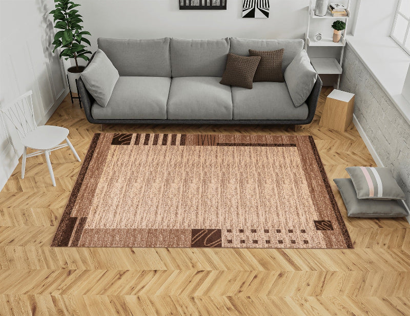 Living room with a brown patterned rug, sofa, and wooden floor.