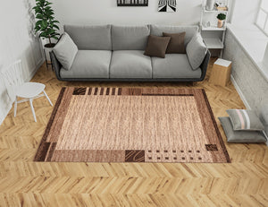 Living room with a brown patterned rug, sofa, and wooden floor.