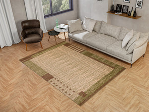 Brown and green rug on a wooden floor, featuring a sofa and chair.