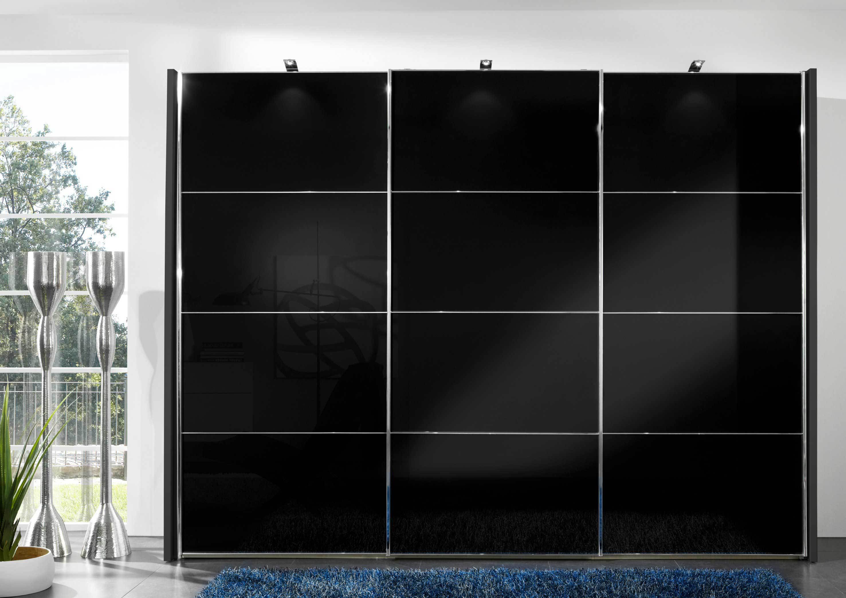 A modern sliding door wardrobe with polished chrome handles and a dark finish, possibly with glass or mirrored panels.